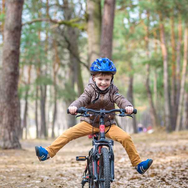 A kid riding his bicycle.